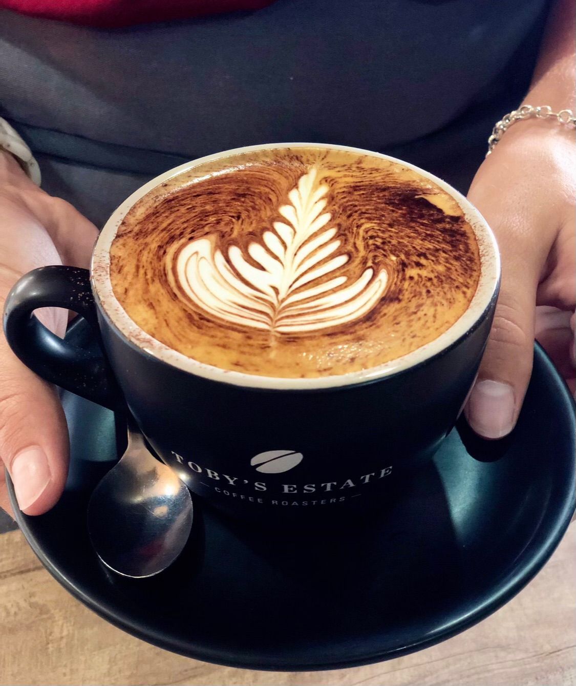 A Five Coffee Drinks With Latte Art, on Black Saucers, Viewed From Above — Flour in Yeppoon, QLD