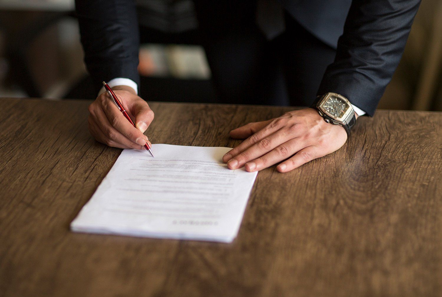 Man Signing a Document — Evansville, IN — Scates Law Firm