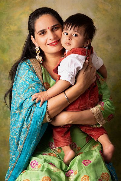 A woman is holding a baby in her arms.