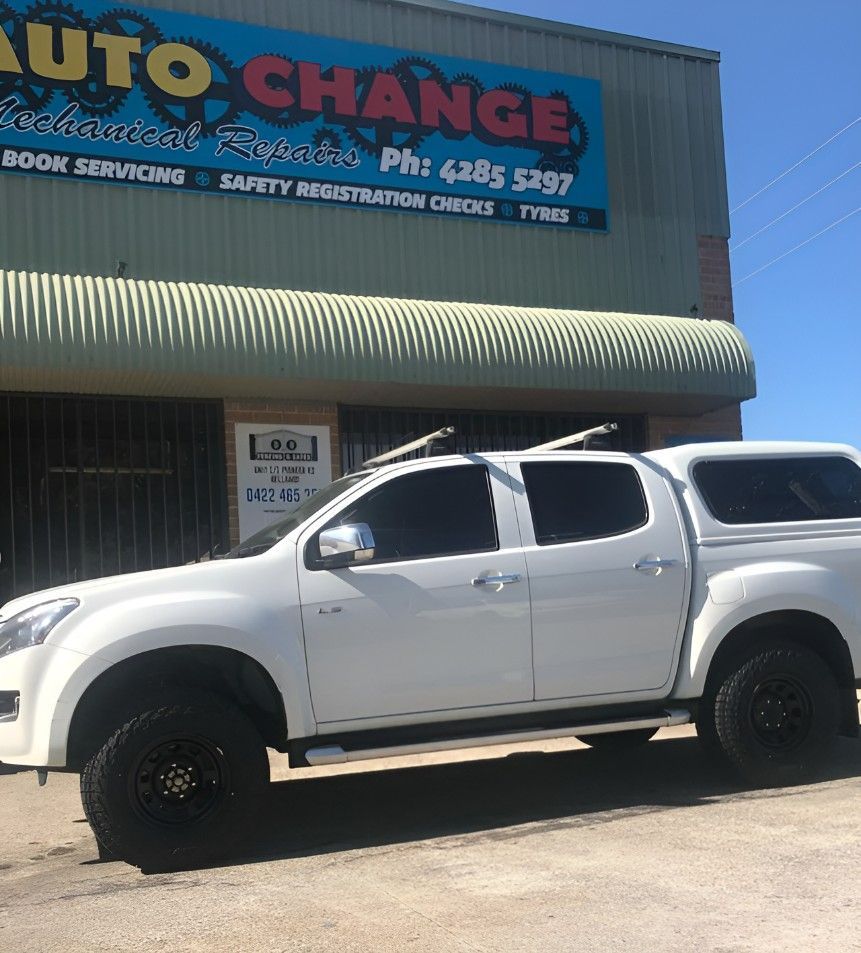 A White Truck is Parked in Front of a Building — Autochange Mechanical Repairs & Tyres in Bellambi, NSW