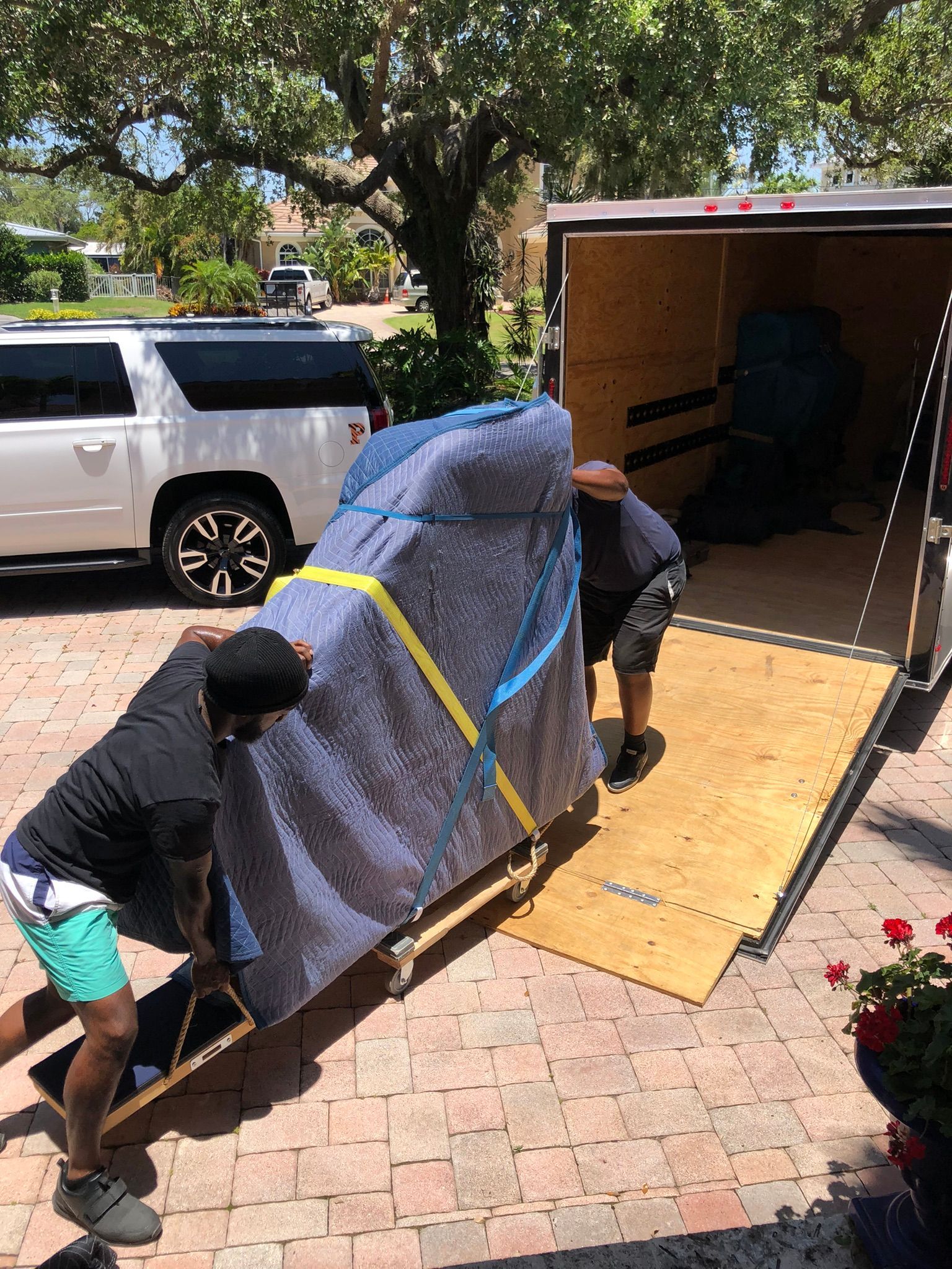 Two Movers Carrying Cardboard Boxes