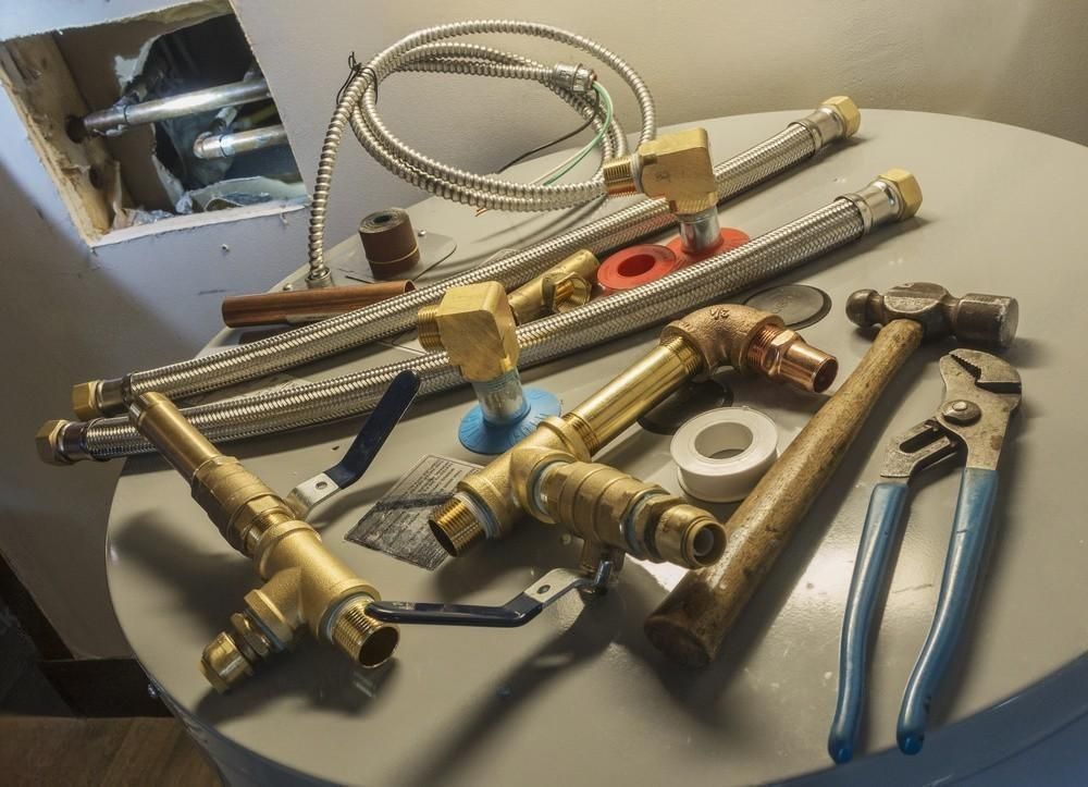 a bunch of brass pipes and tools on a table