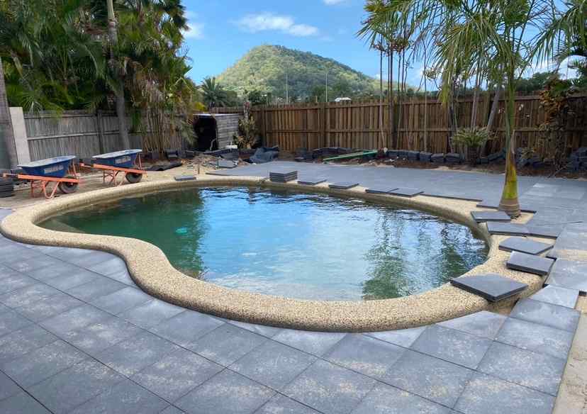 Concrete Pavers Getting Installed Around Swimming Pool  — Trinity Landscape in Cairns, QLD