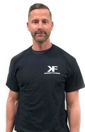 A man with a beard is wearing a black t-shirt.