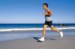 Man running on beach | Dr. James H. Courniotes II Foot Specialist Associates in Springfield, MA