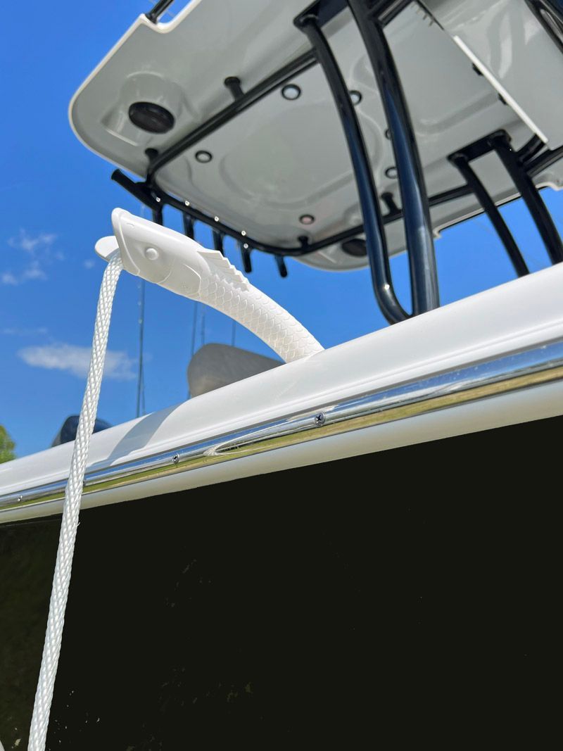 A boat with a white roof and a blue sky in the background