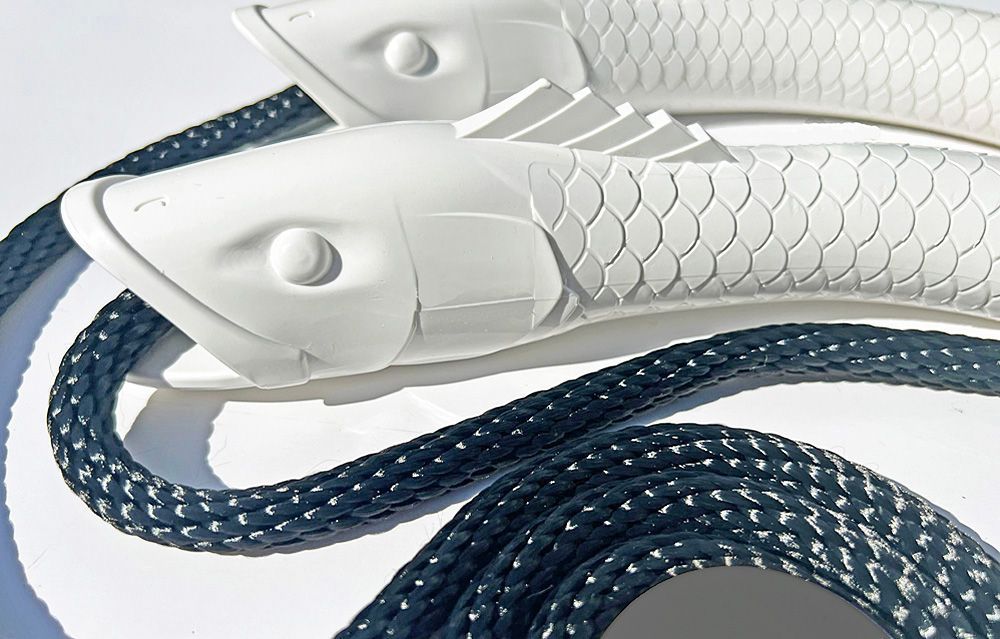 A pair of white fish on a blue rope