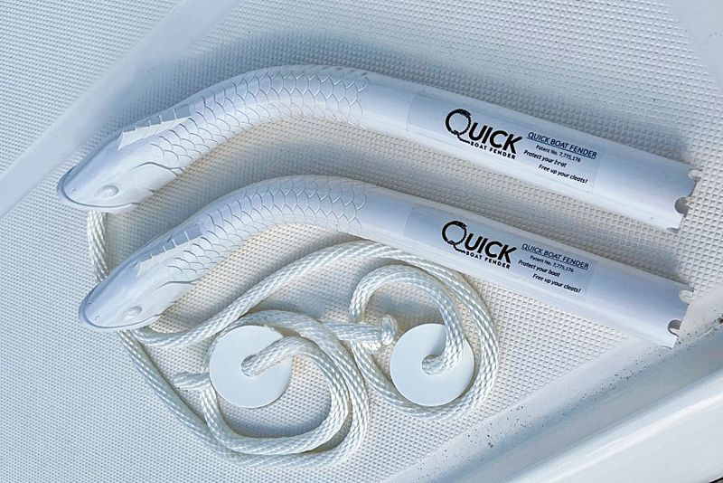 two white quick boat fenders with ropes attached to them