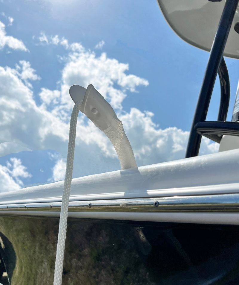A white rope is attached to the side of a boat