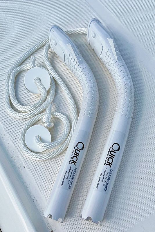 Two white ropes are sitting on top of a white surface.