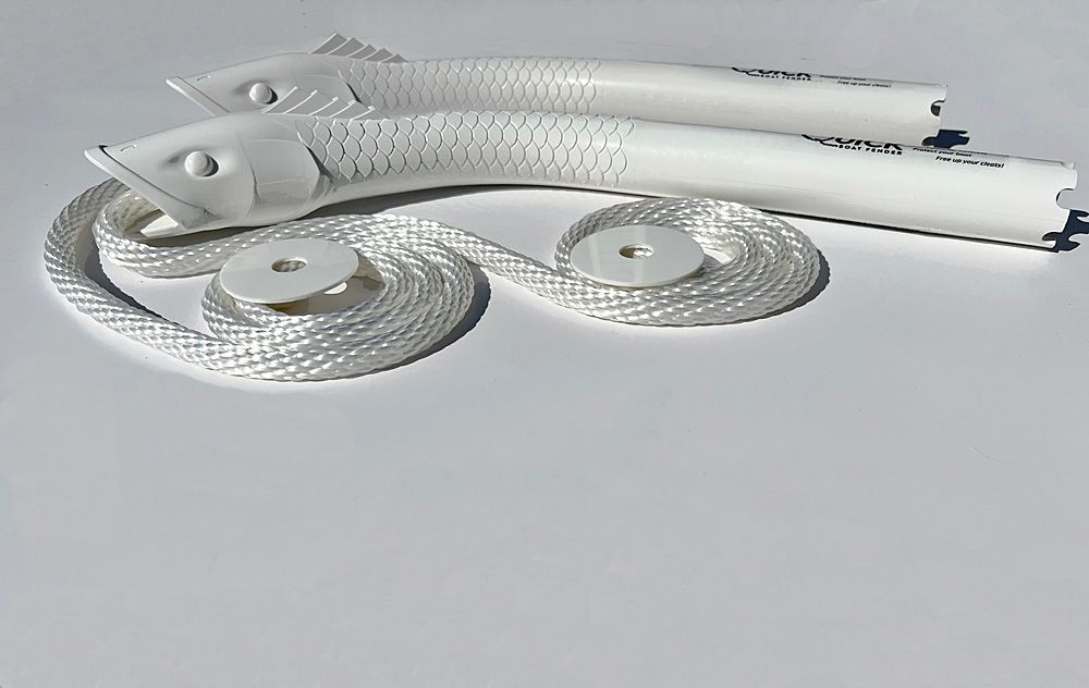 A pair of white fish shaped rope holders on a white surface