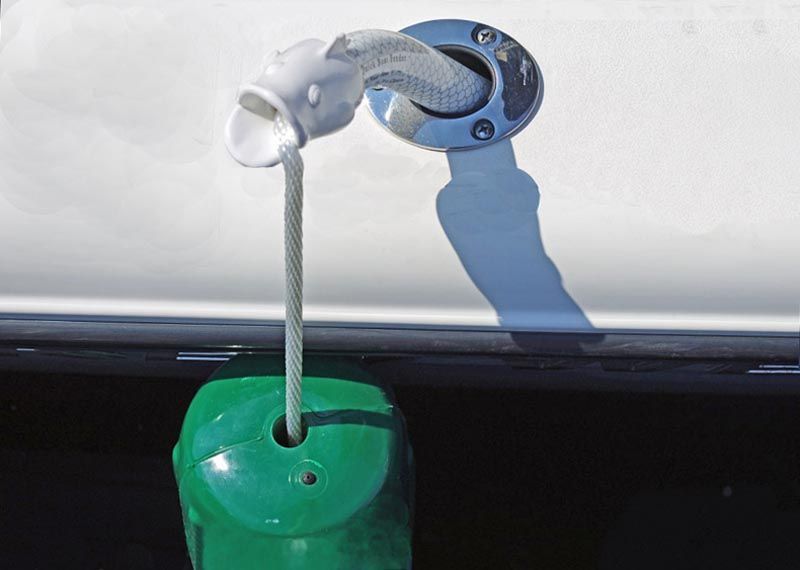 A green buoy is attached to the side of a boat