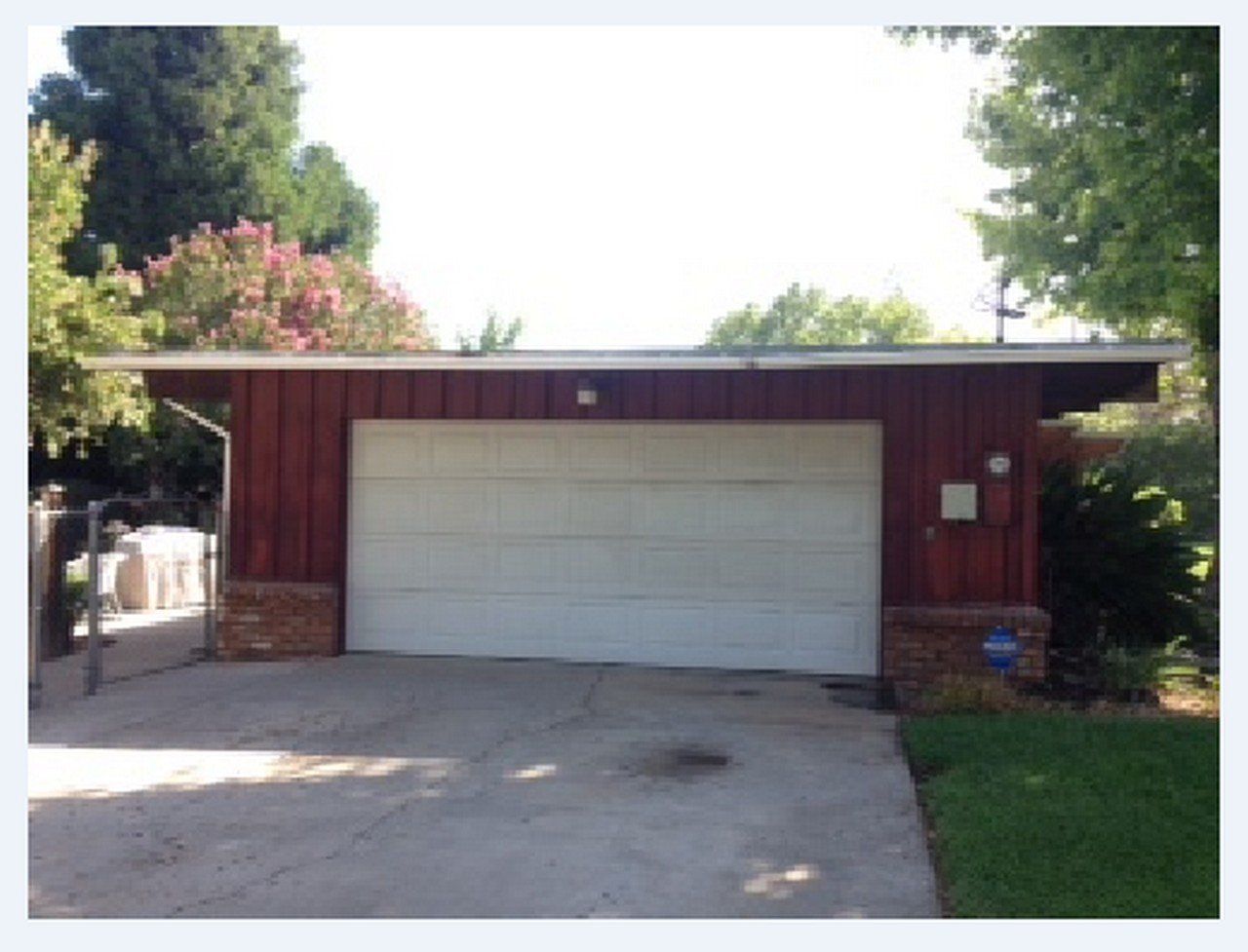 A red garage with a white garage door