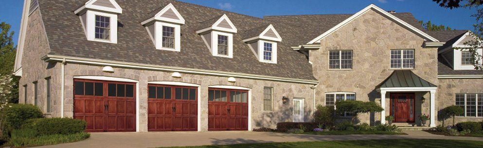 3 Garage doors on the front of a nice home