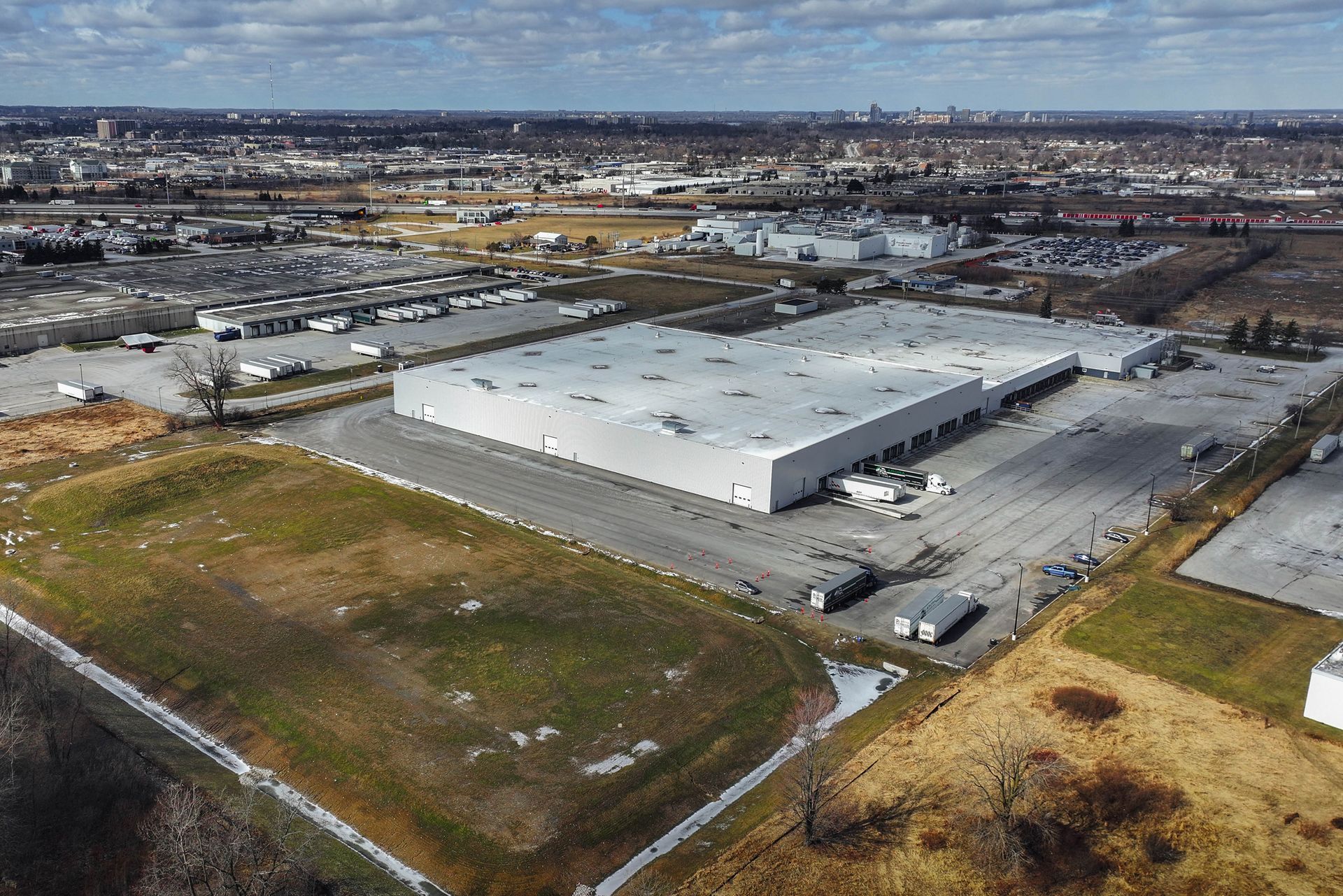 an aerial view of a large warehouse in the middle of a city build by J-AAR construction services 