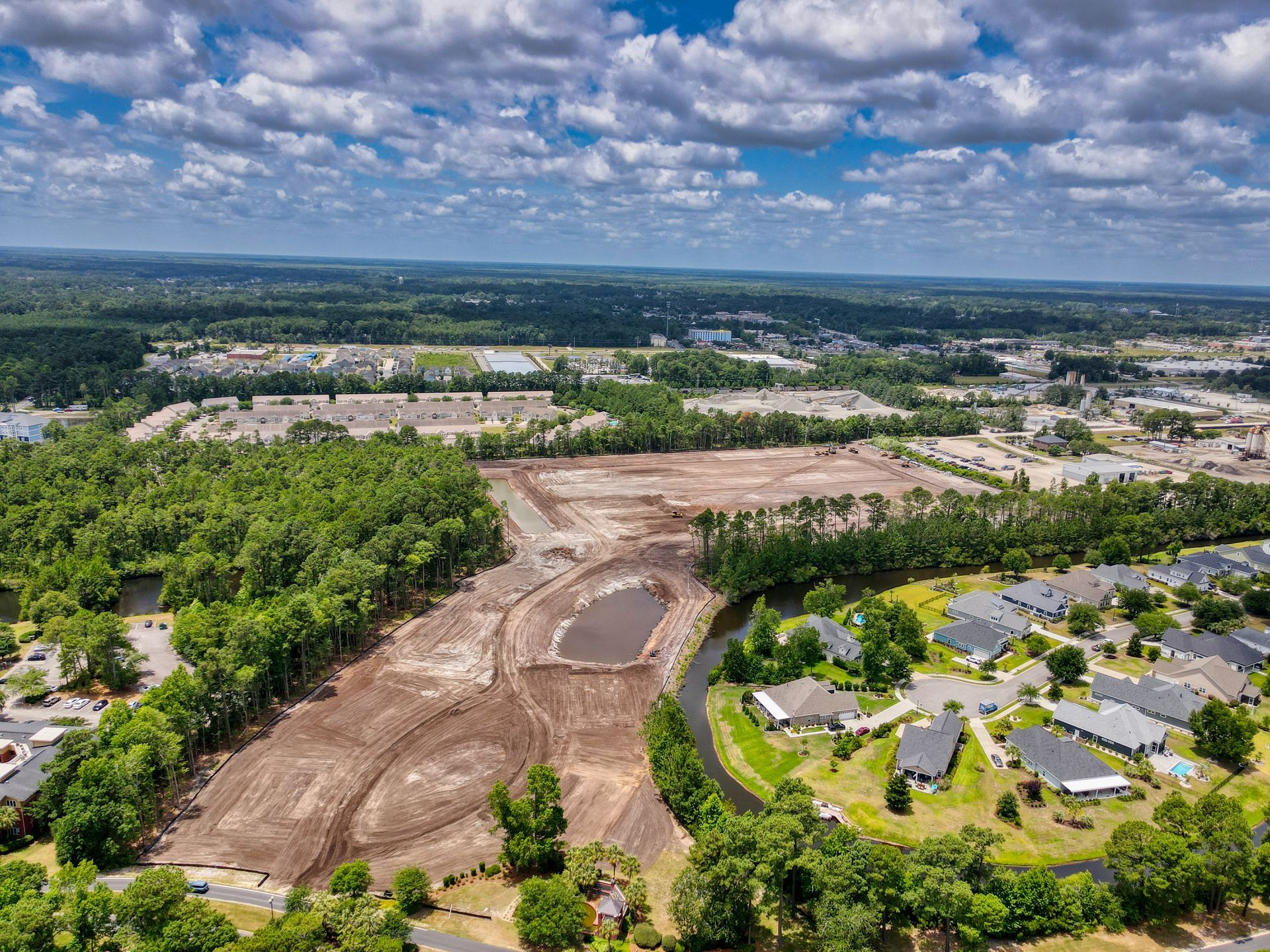 An aerial view of a residential area with lots of trees and houses.
