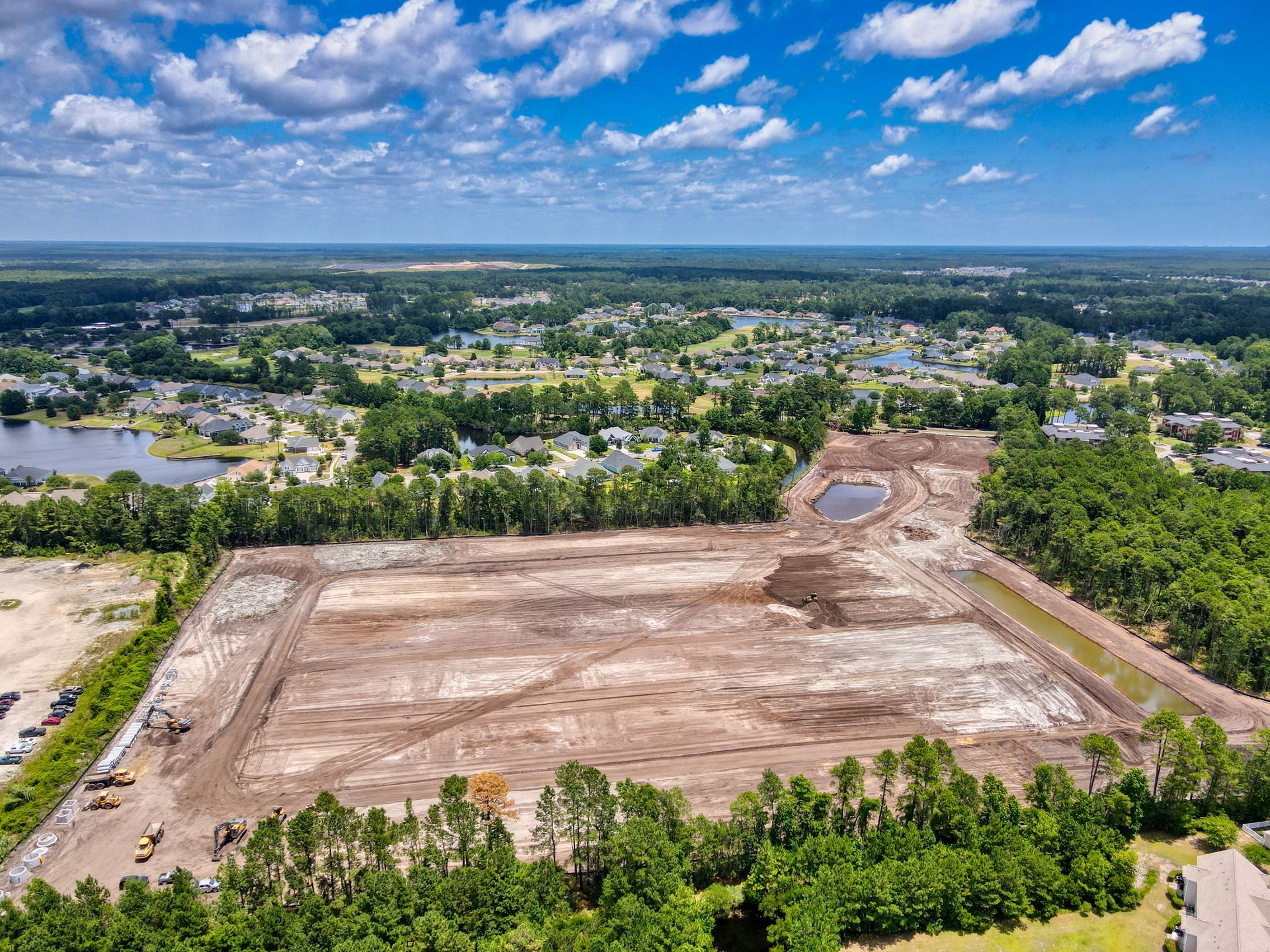 An aerial view of a construction site in the middle of a forest.