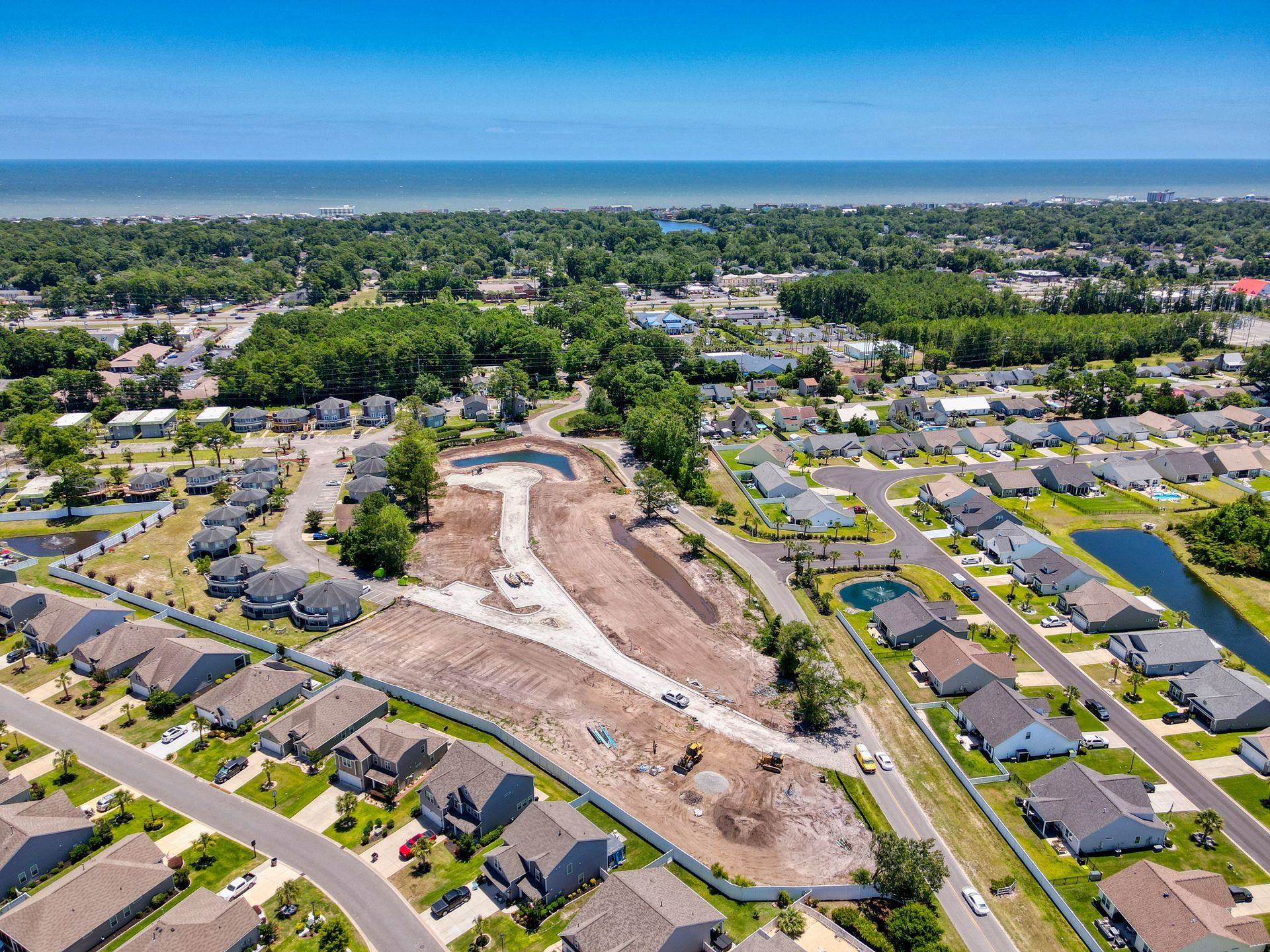An aerial view of a residential area near the ocean.