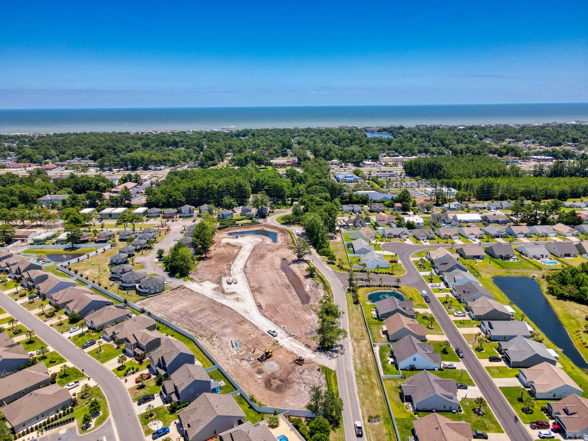 An aerial view of a residential area next to the ocean.