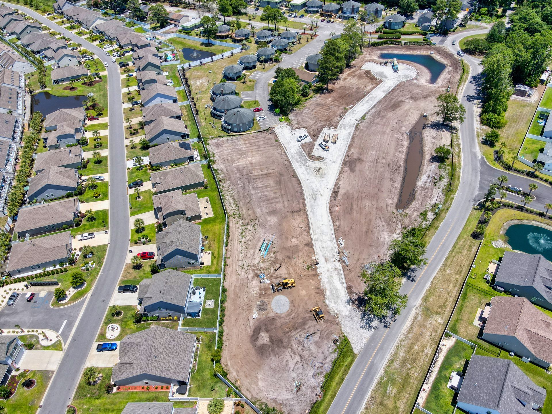 An aerial view of a residential area with lots of houses and roads.