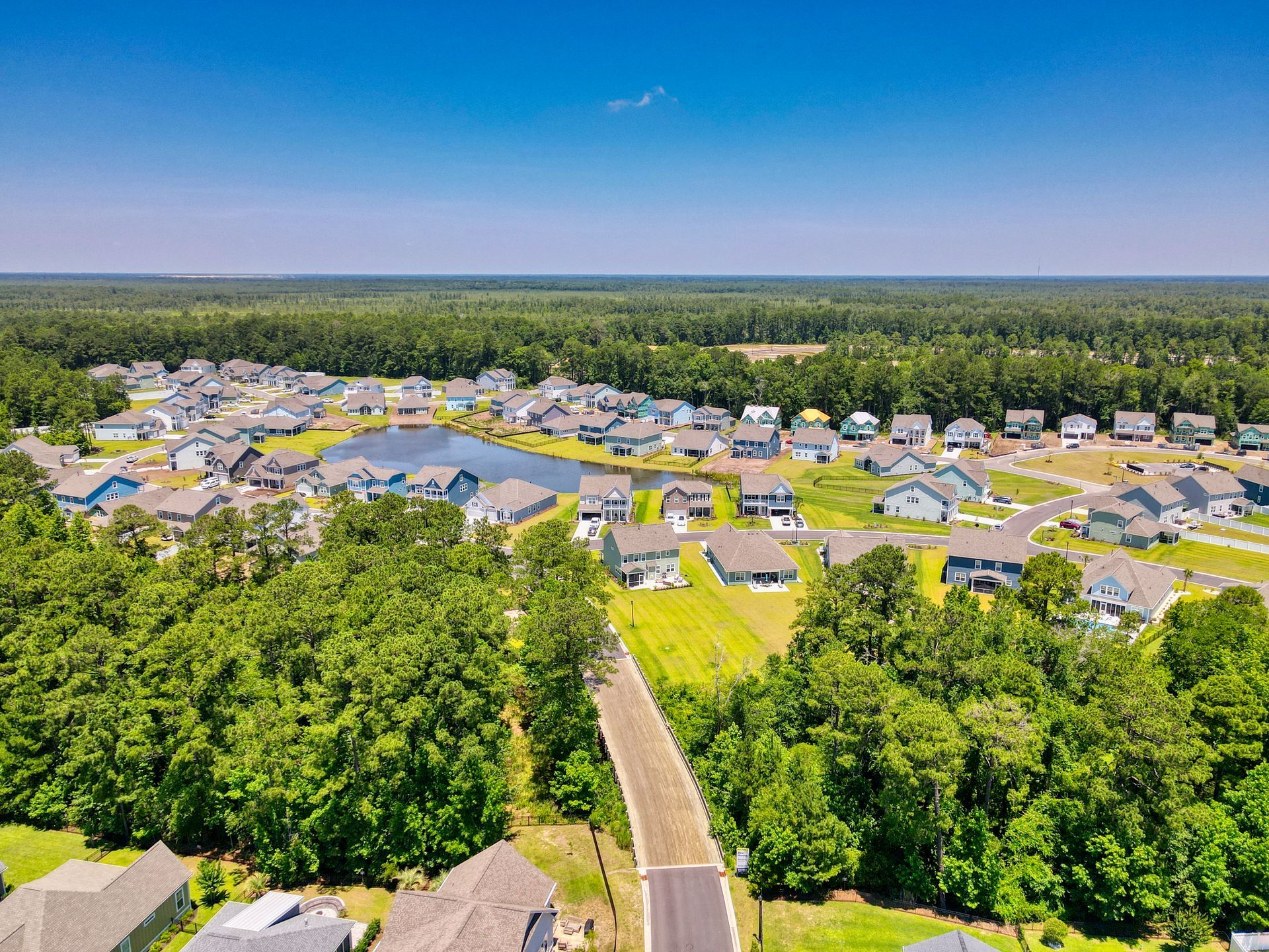 An aerial view of a residential area surrounded by trees and houses.
