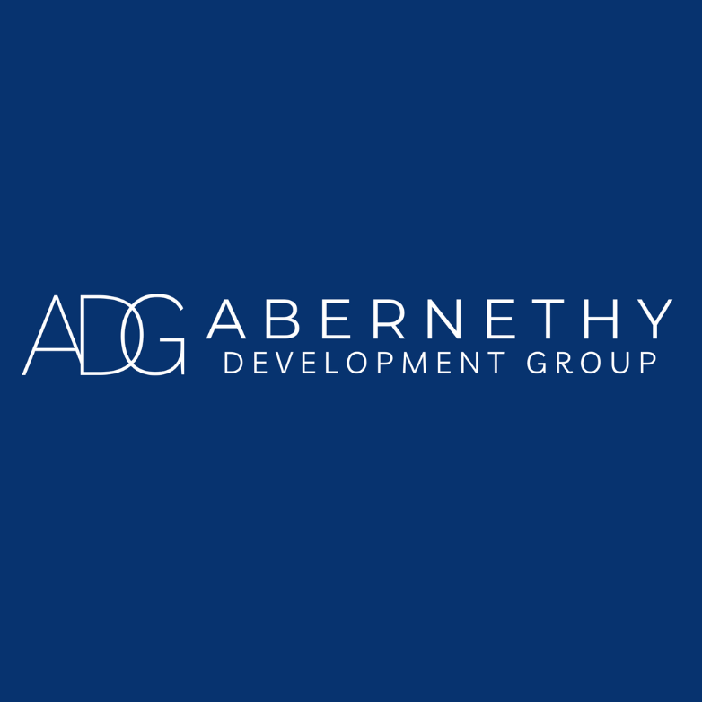 The adg abernethy development group logo is on a blue background