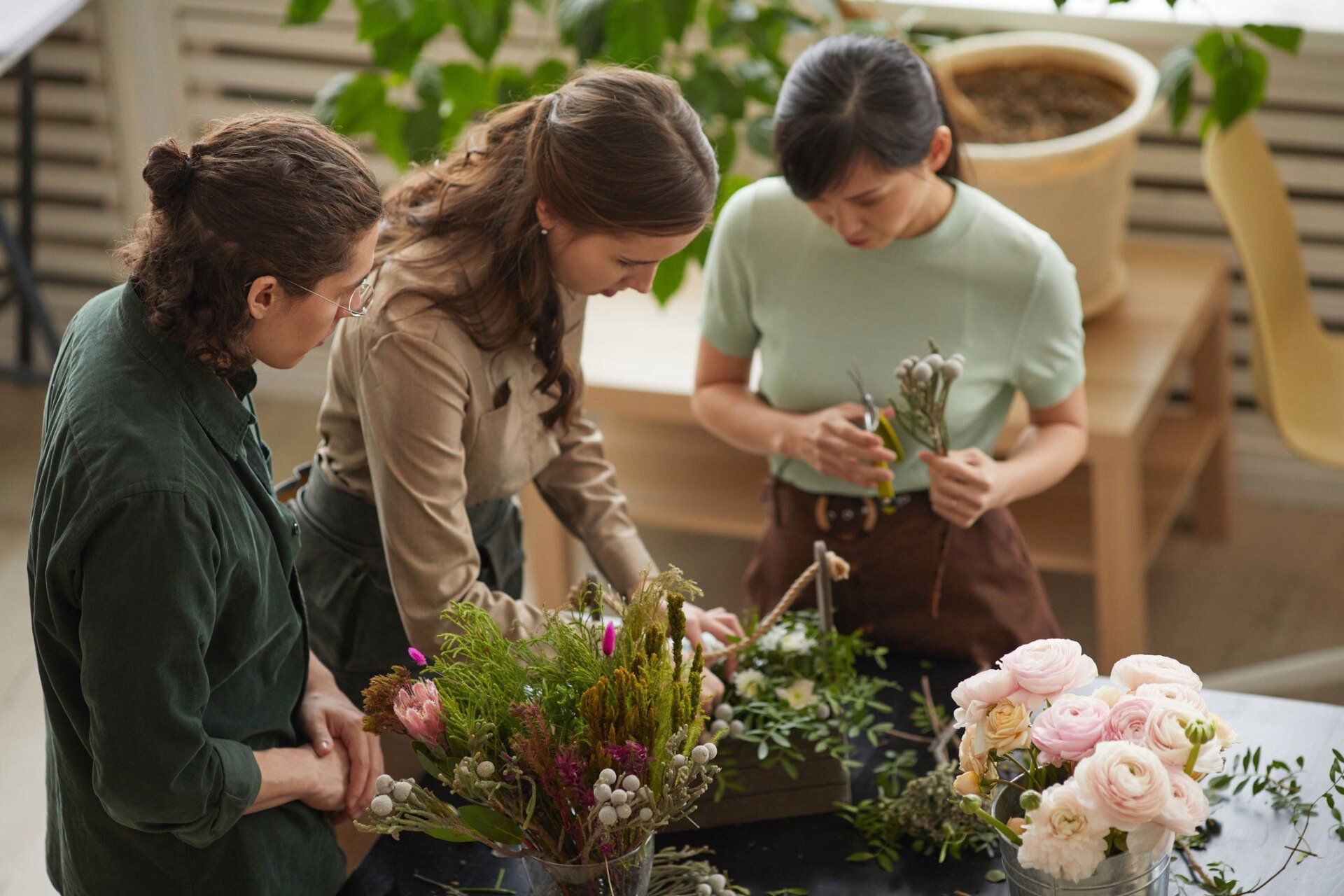 Group of People Creating Flower Compositions in Workshop — Adelaide, SA — MH Southern Support
