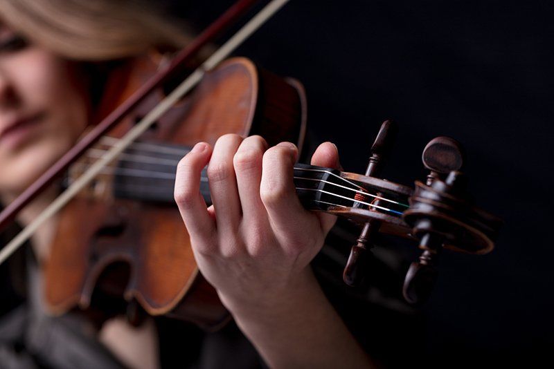 a lady learning to play violin