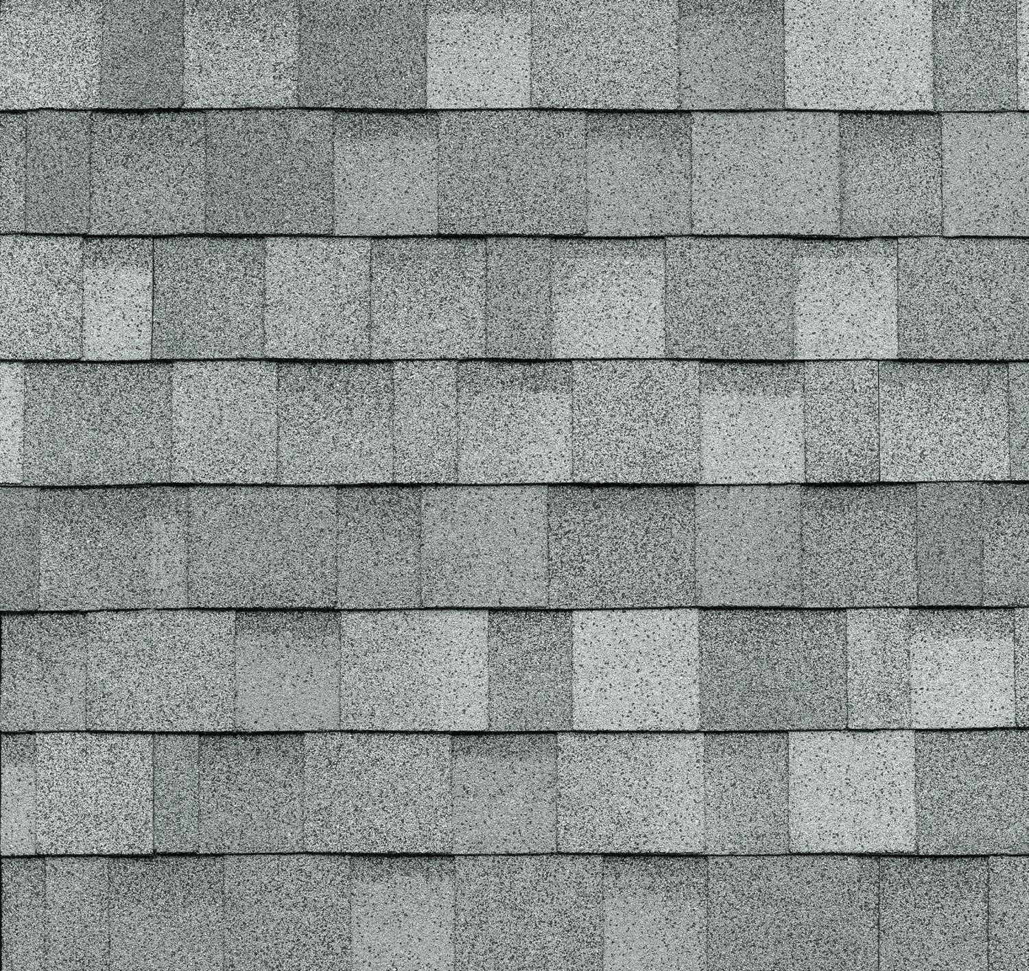 A close up of a row of gray shingles on a roof.