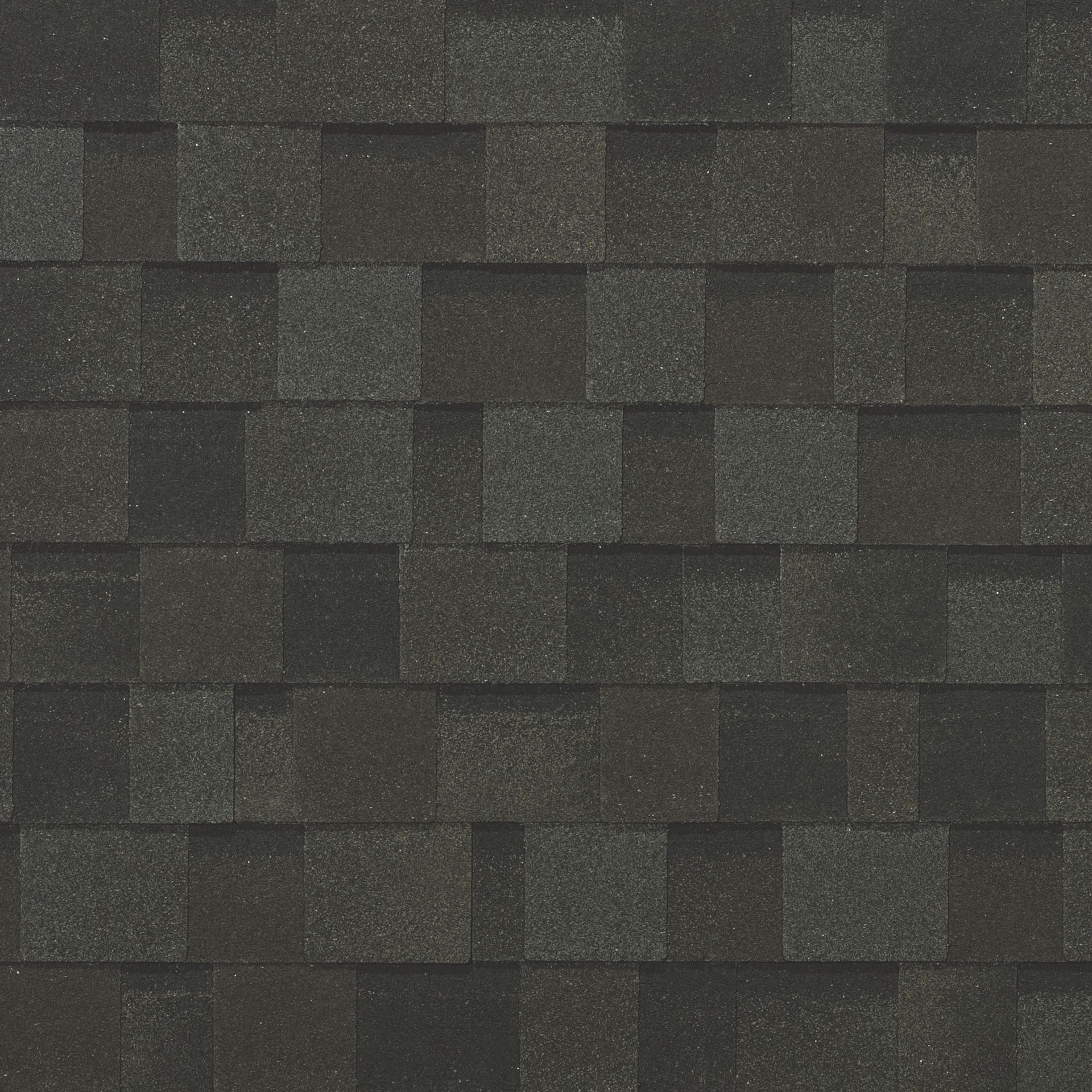 A close up of a roof with black shingles