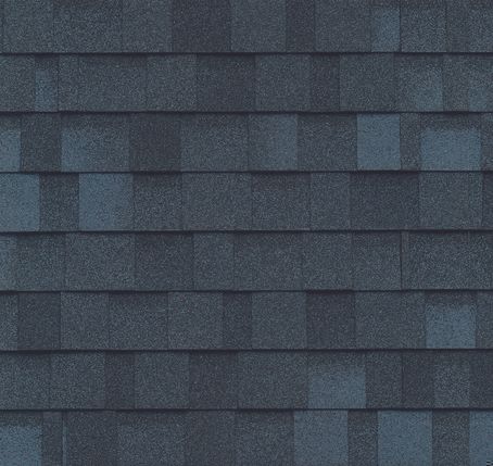 A close up of a roof with blue shingles.