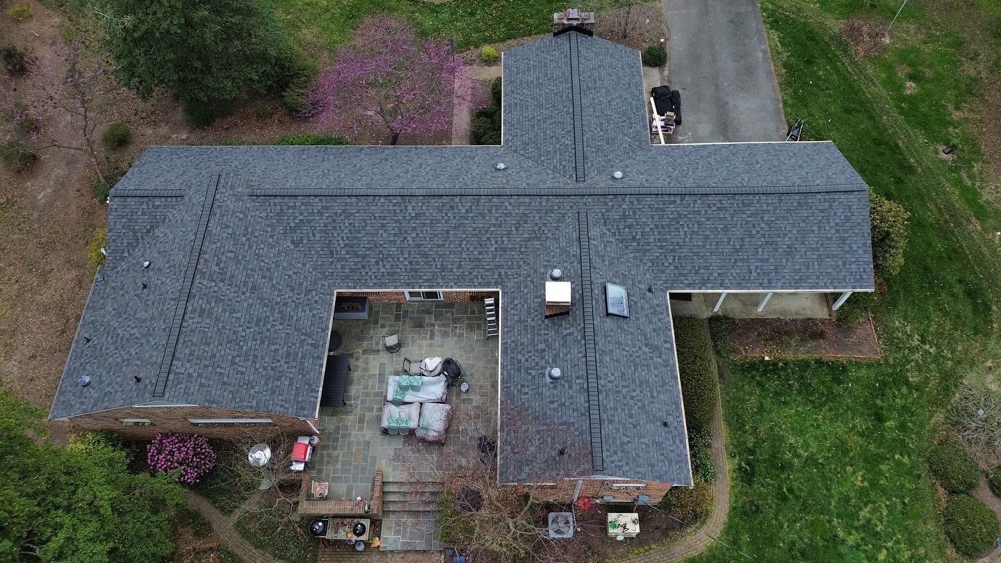 An aerial view of a house with a new roof.