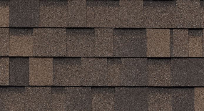 A close up of a roof with brown and black shingles.