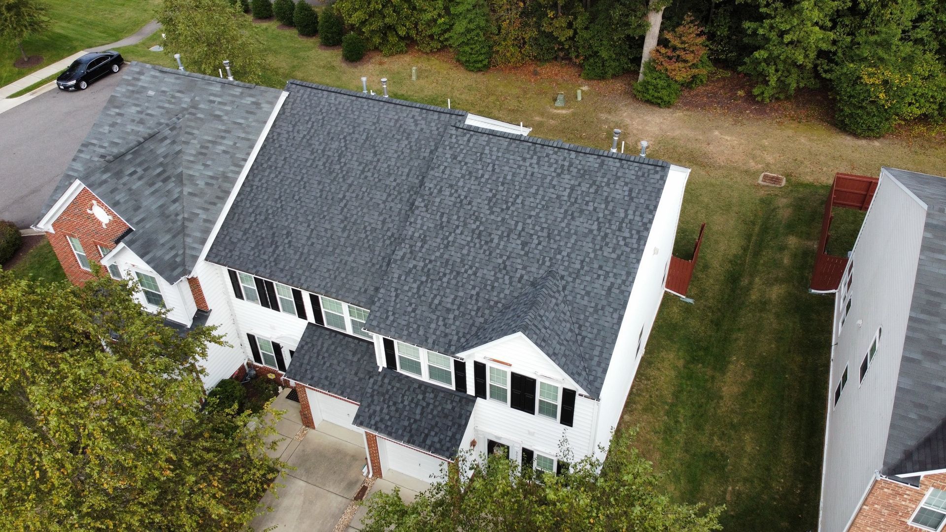 An aerial view of a house with a new roof.