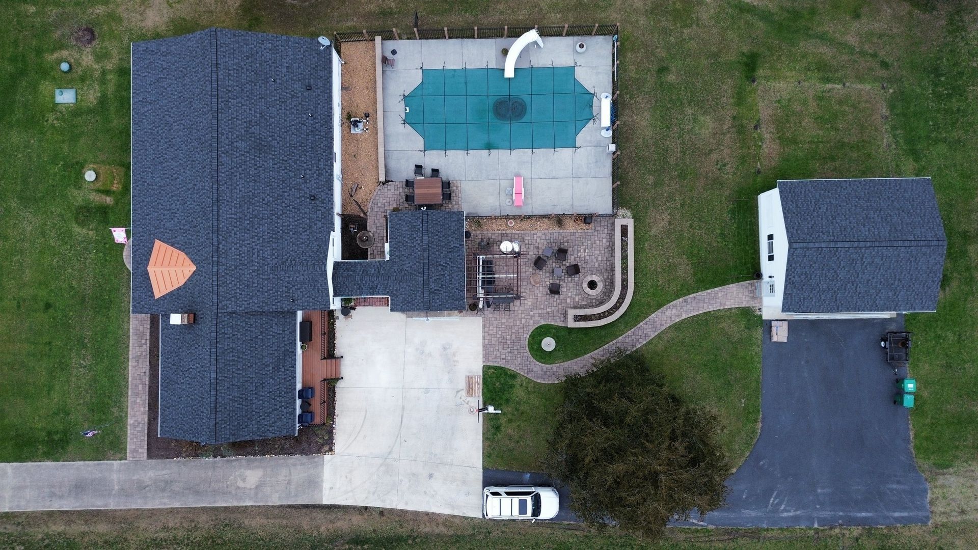 An aerial view of a house with a pool in the backyard.