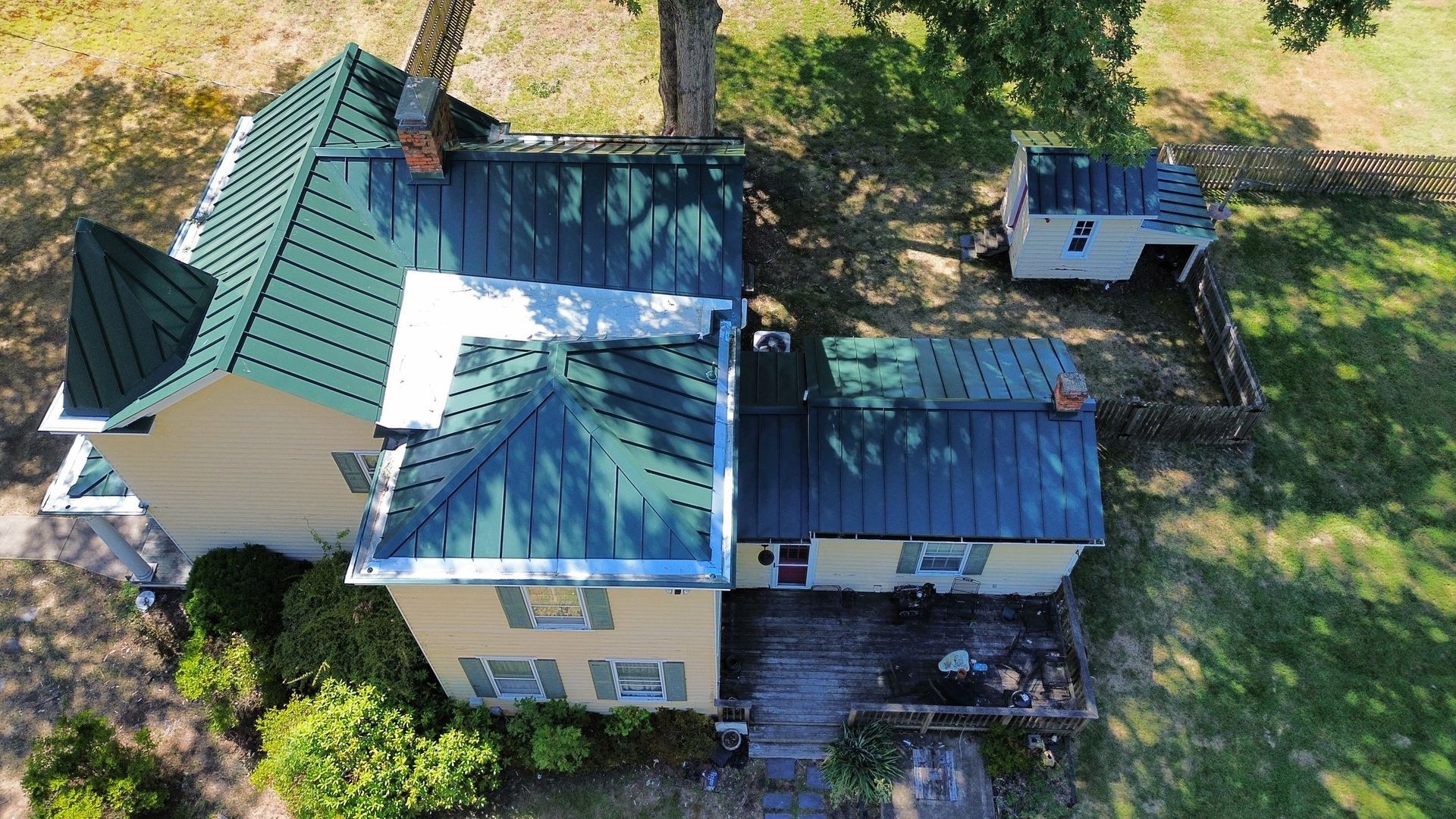An aerial view of a house with a green roof