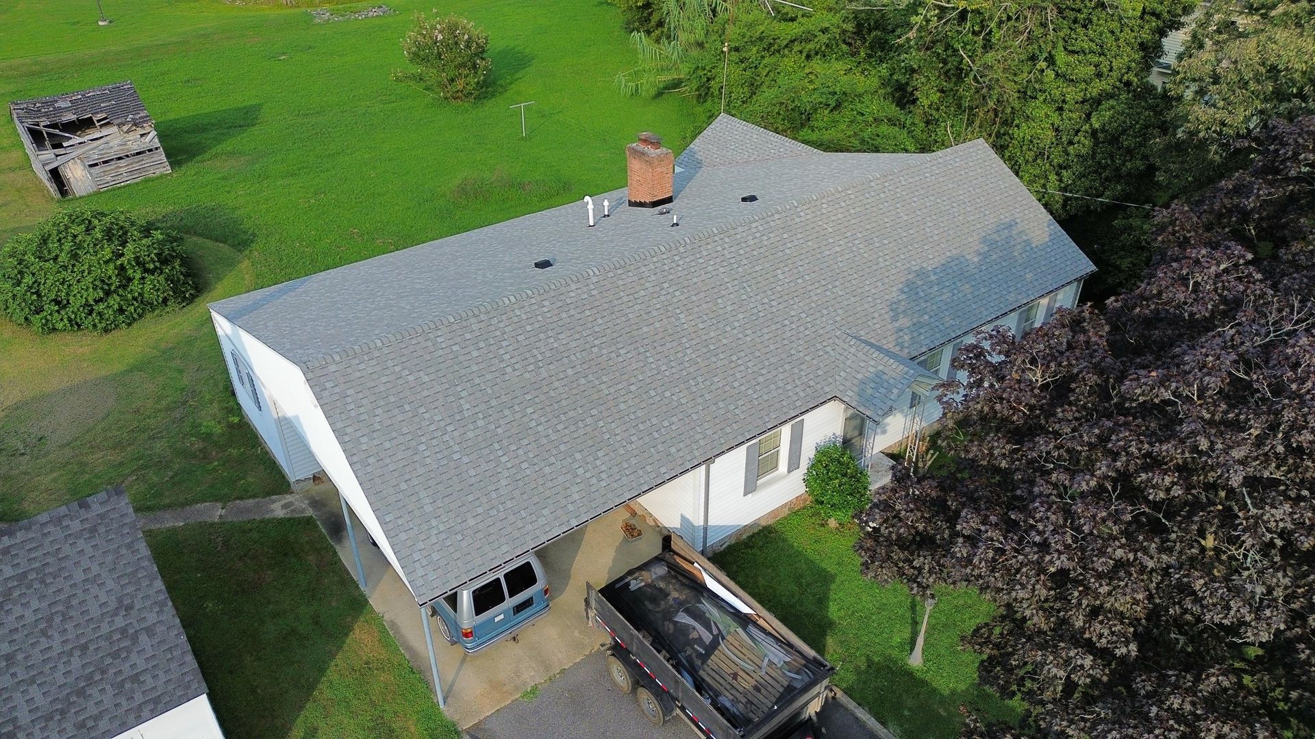 An aerial view of a house with a truck parked in front of it.