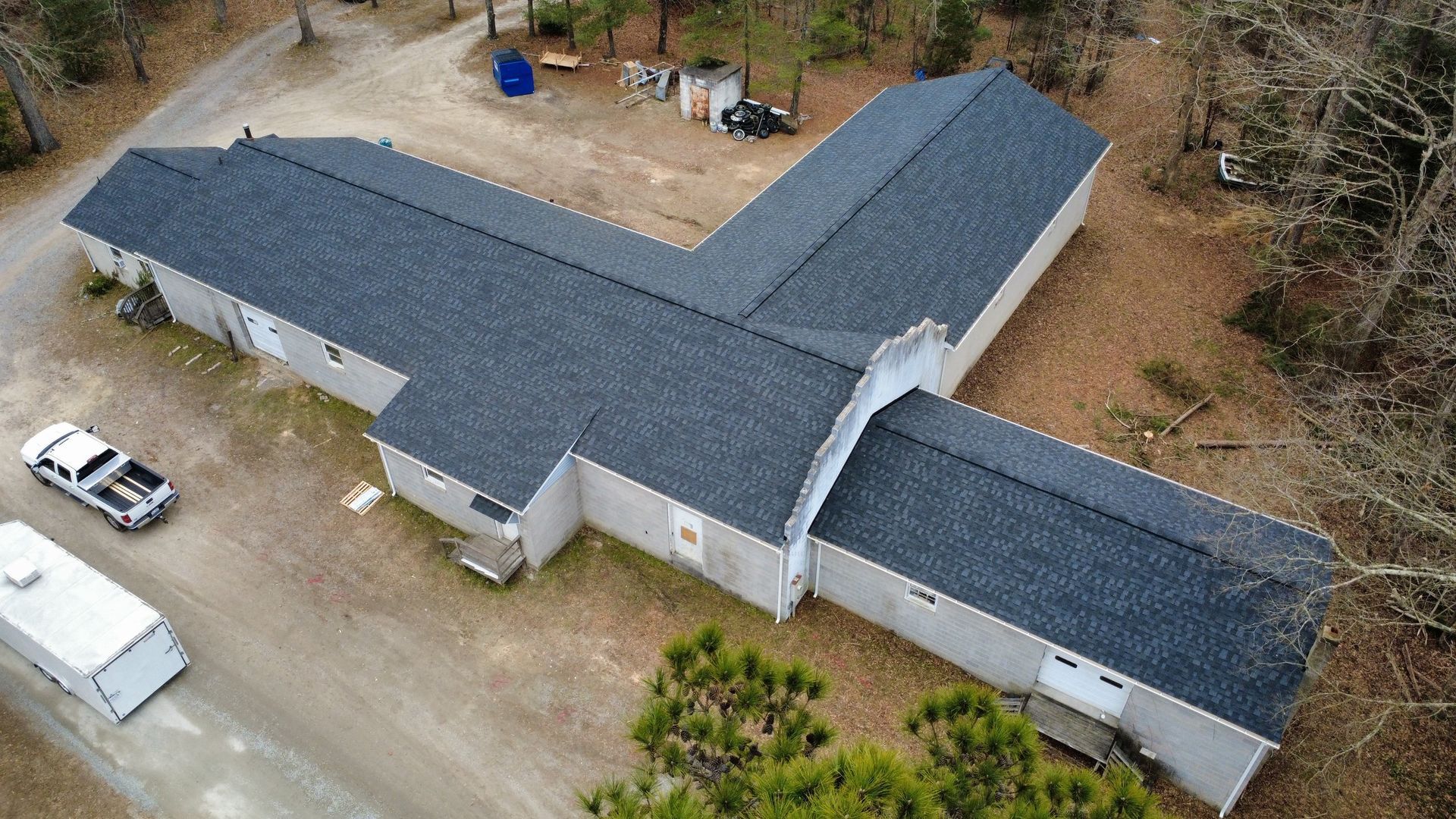 An aerial view of a large house with a new roof.