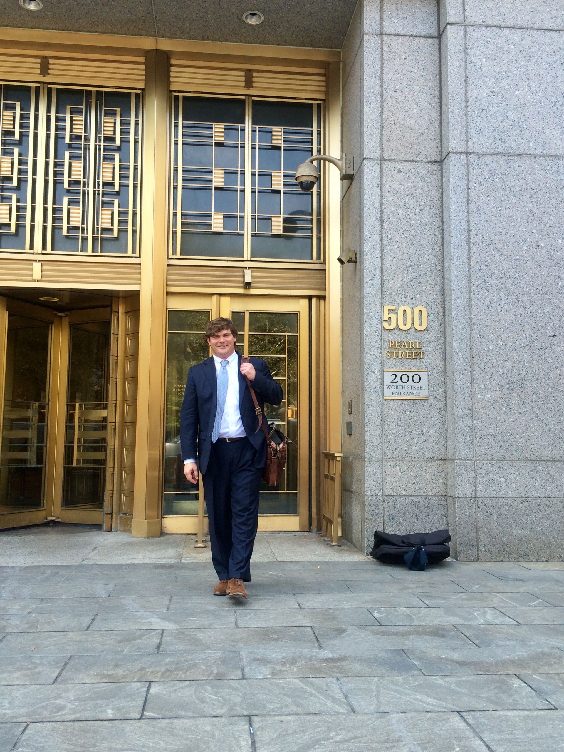 Wesley D. Ehrhardt standing in front of Daniel Patrick Moynihan United States Courthouse
