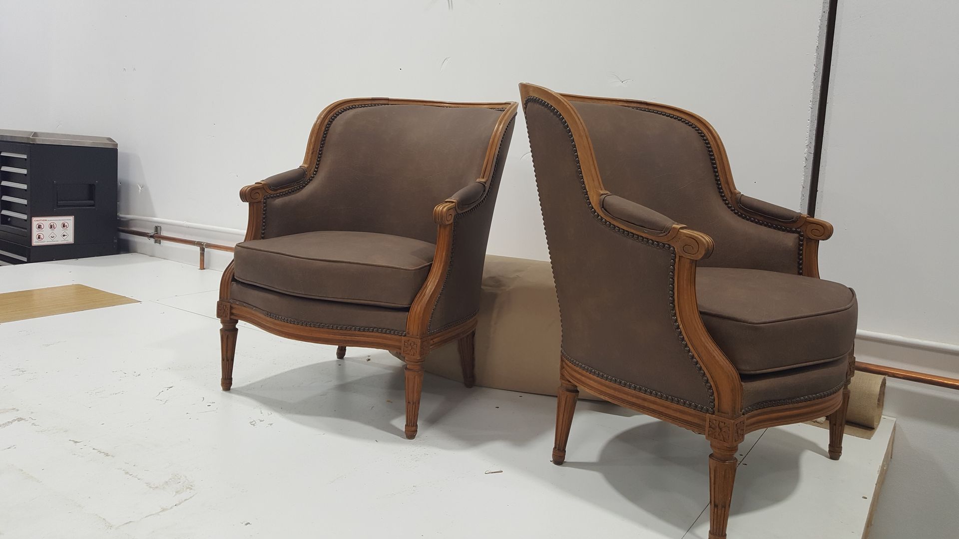 Two chairs are sitting next to each other on a white table.