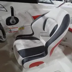 A black and white seat on a boat with a steering wheel.