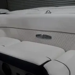 A close up of a white couch on a boat.