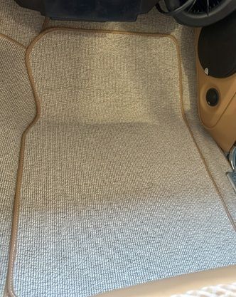 Tan car interior with a subwoofer built in, quilted details.