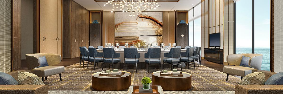 Elegant dining room with large round table, blue chairs, neutral tones, and ocean view.