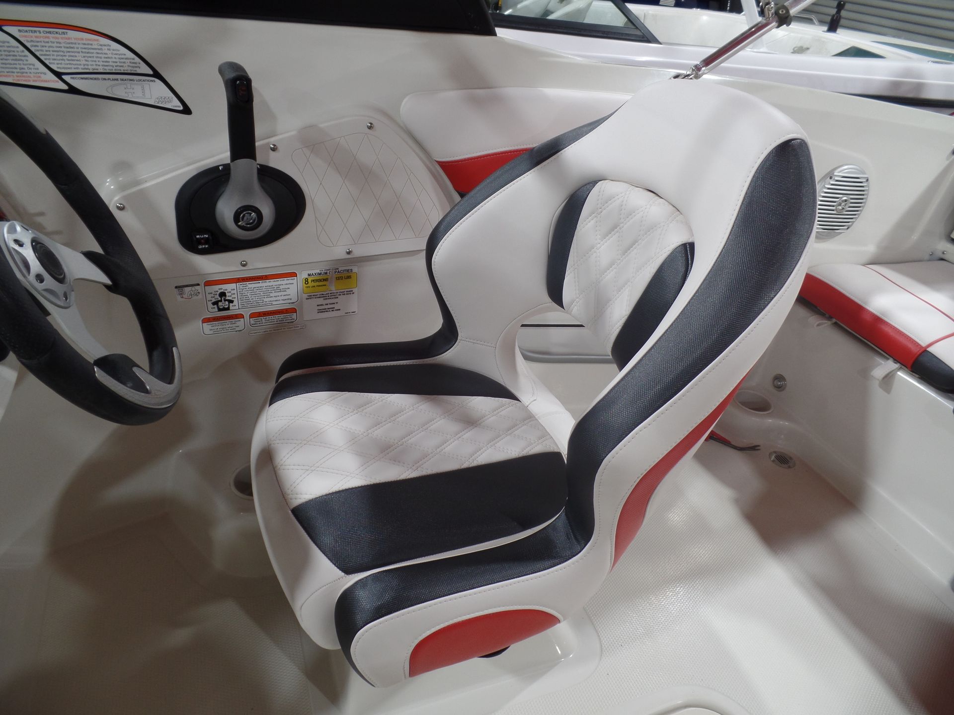 A boat with a black and white seat and a steering wheel