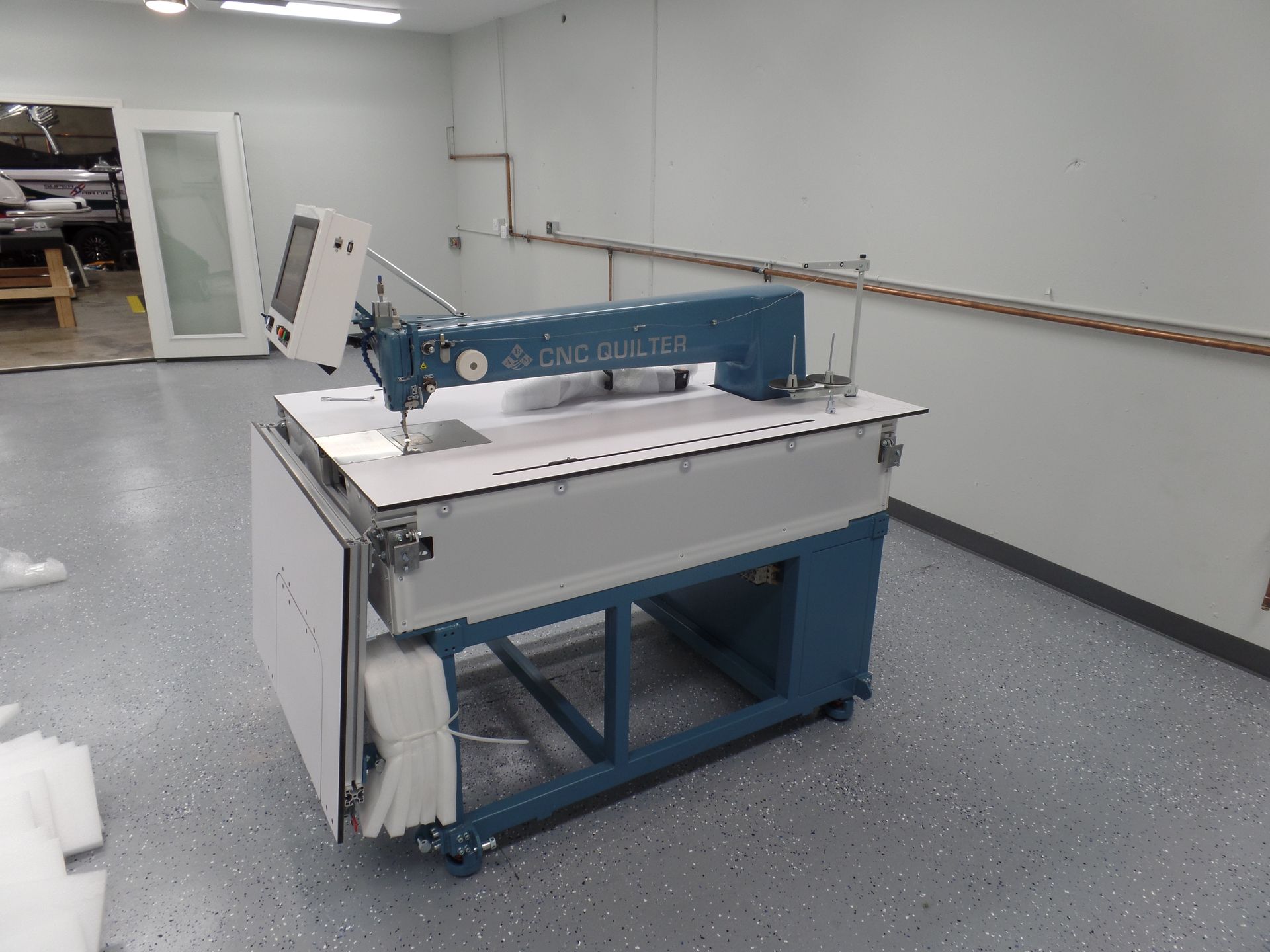 A sewing machine is sitting on a table in a room