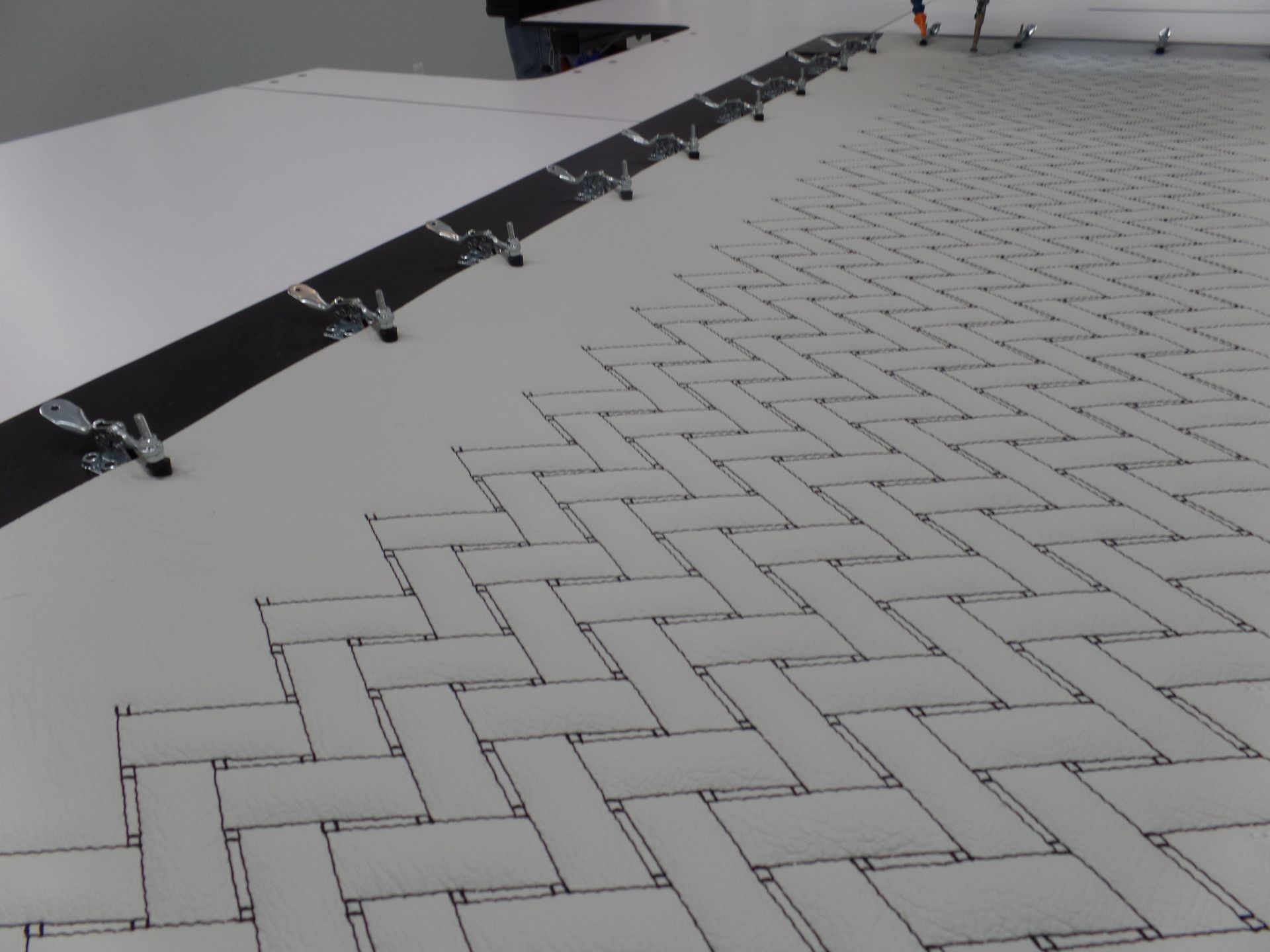 A white tile floor with a herringbone pattern