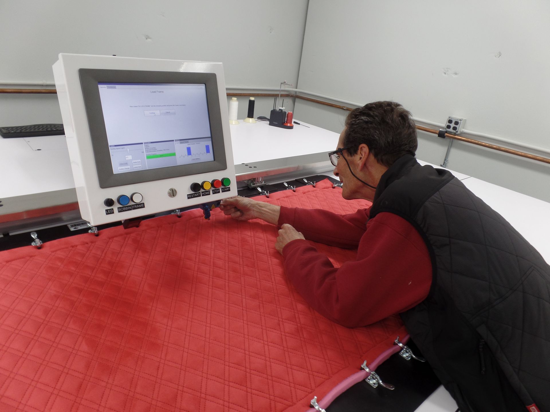 A man is looking at a computer screen in a room.