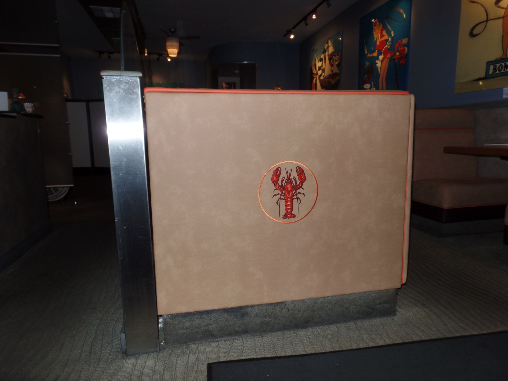 A restaurant booth with a lobster logo on it