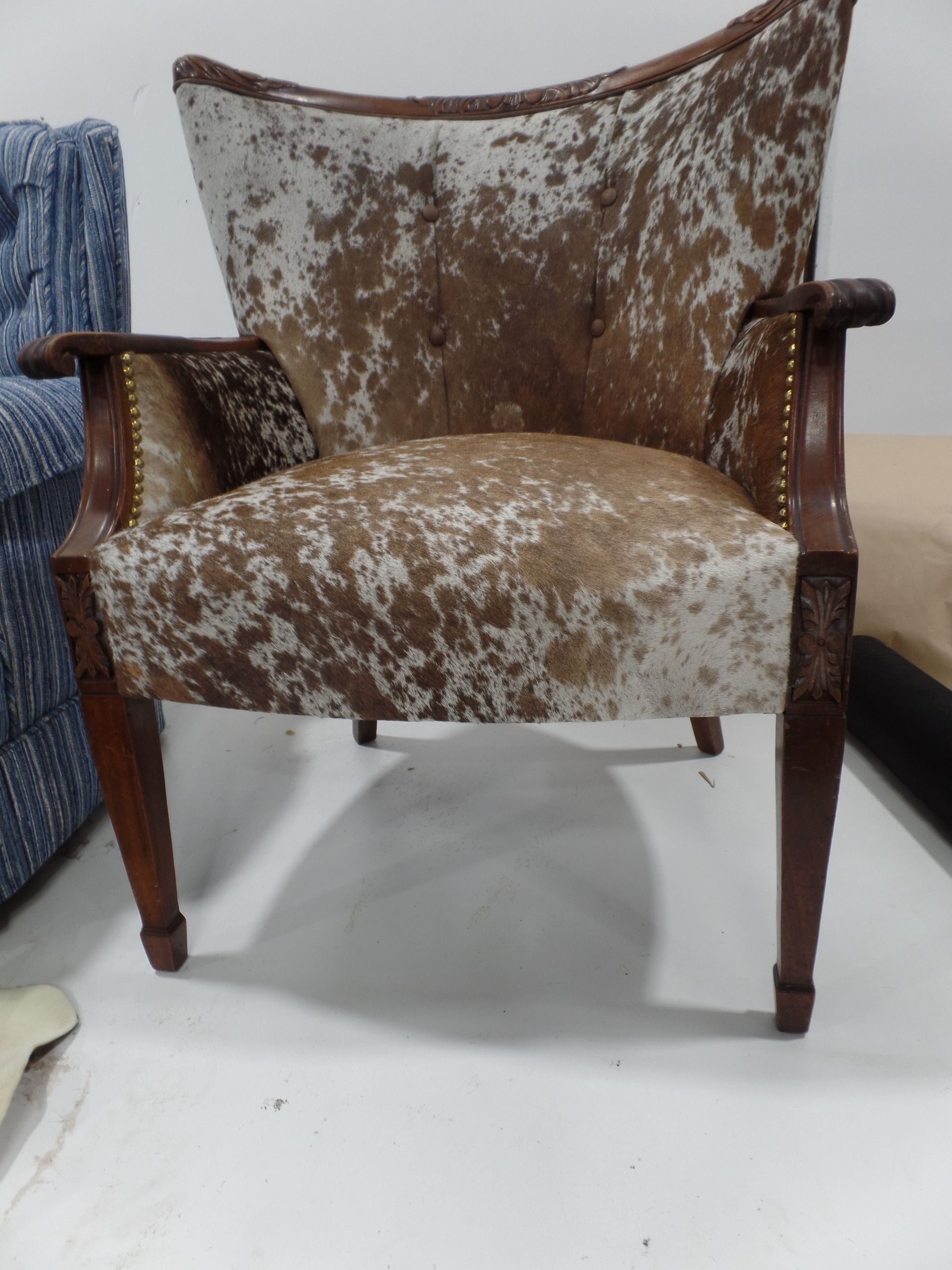 A brown and white chair with a wooden frame